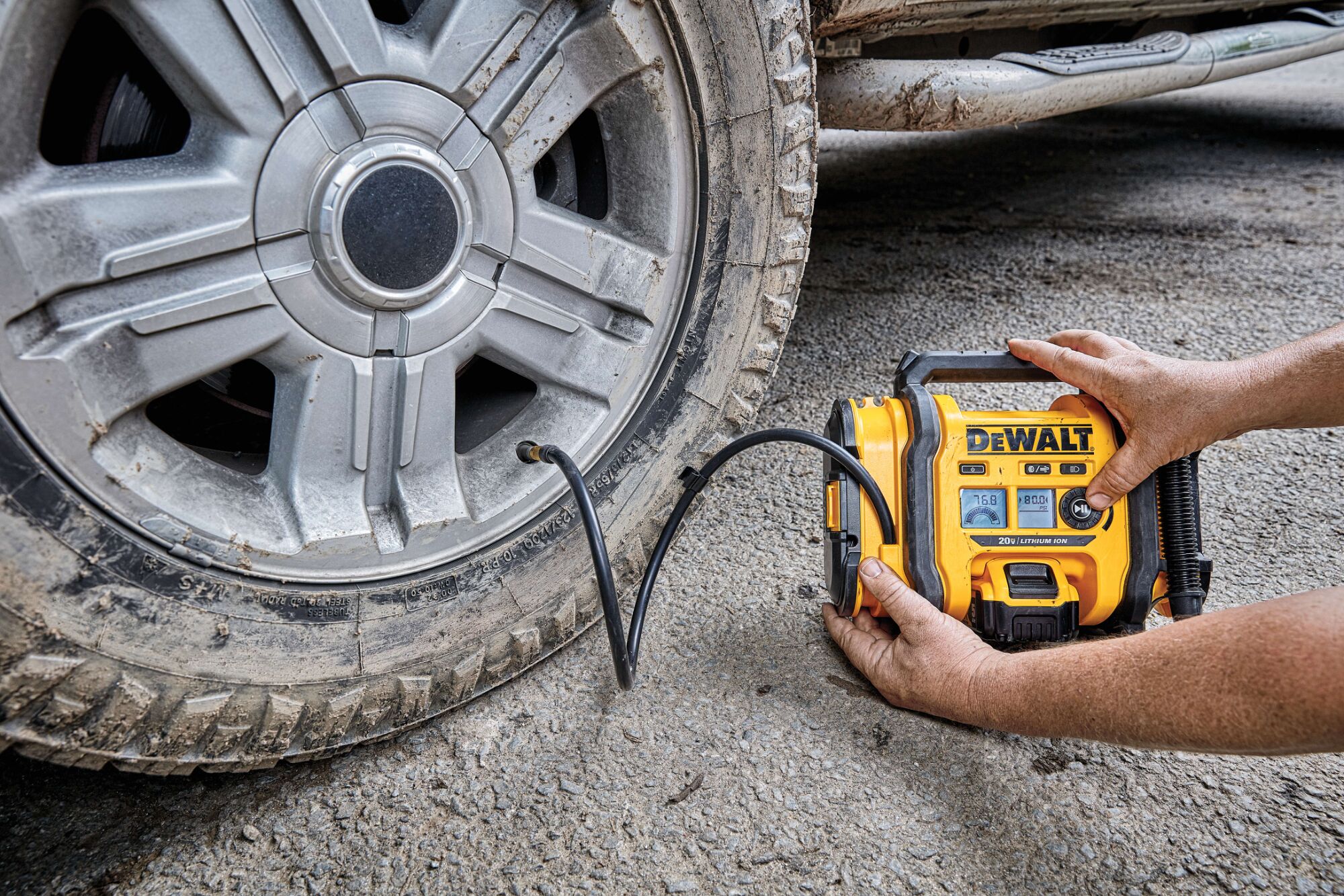 Corded/Cordless Air Inflator being used by a person to inflate a tire