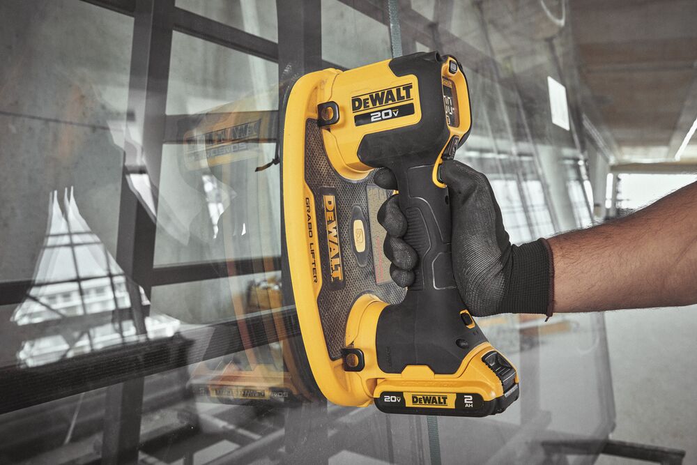 User placing large glass panel with DEWALT 20V MAX Grabo Lifter