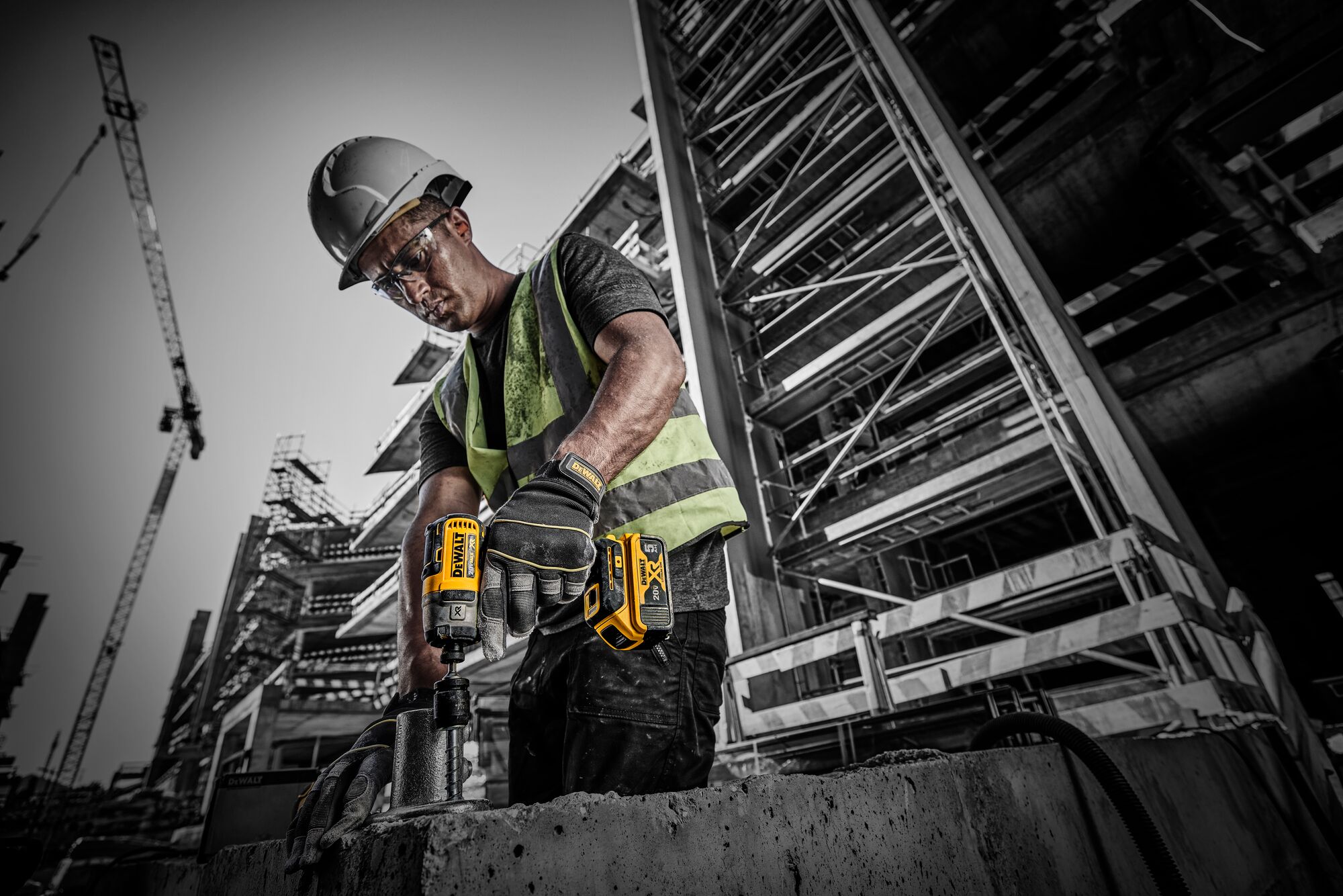 Side view of worker using 3-Speed Impact Driver  on jobsite