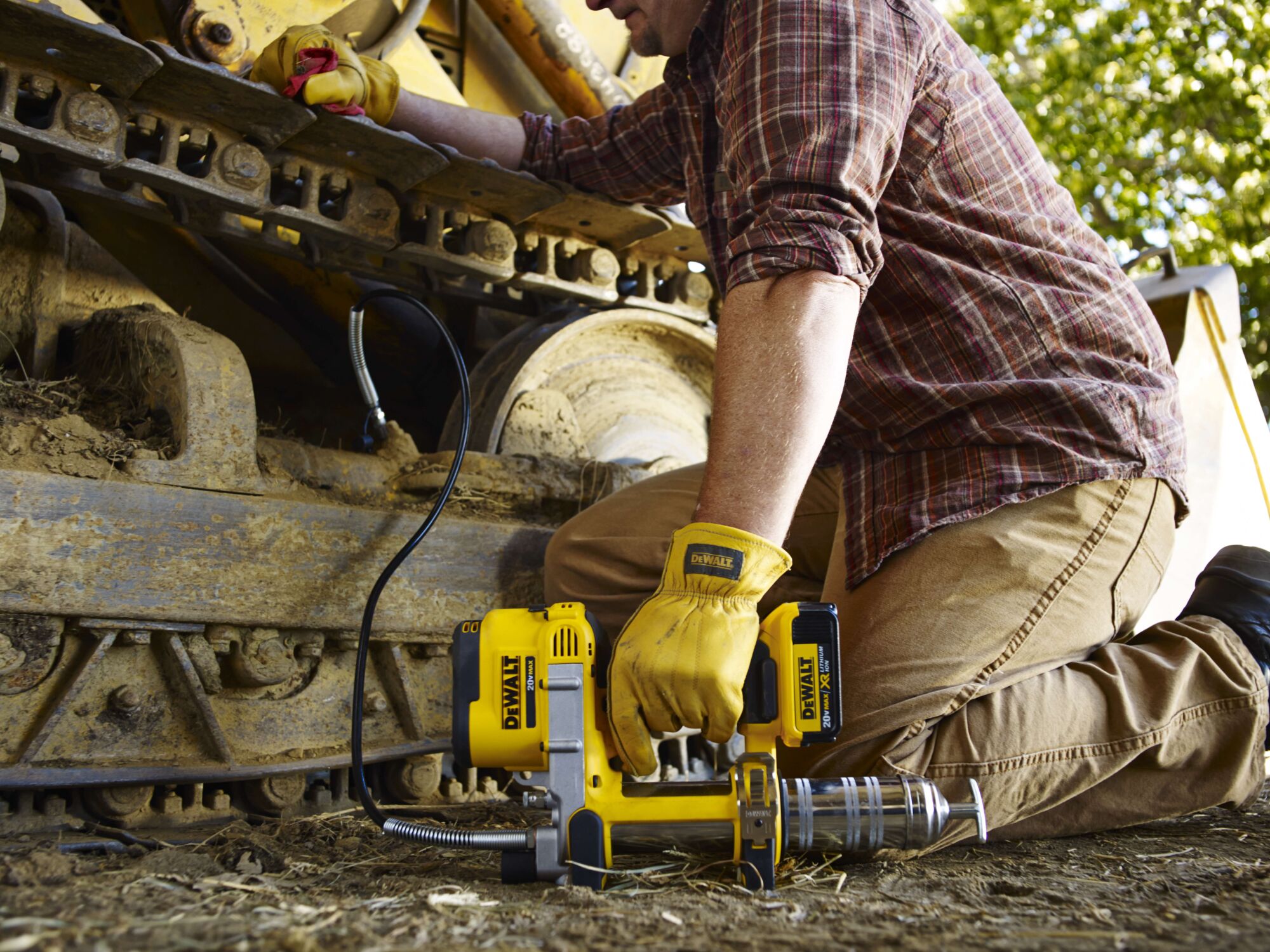 Grease gun being held by person outdoors