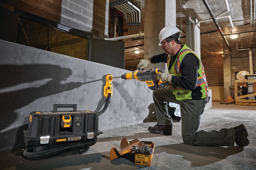 Brushless, cordless SDS MAX combination rotary hammer being used by a person