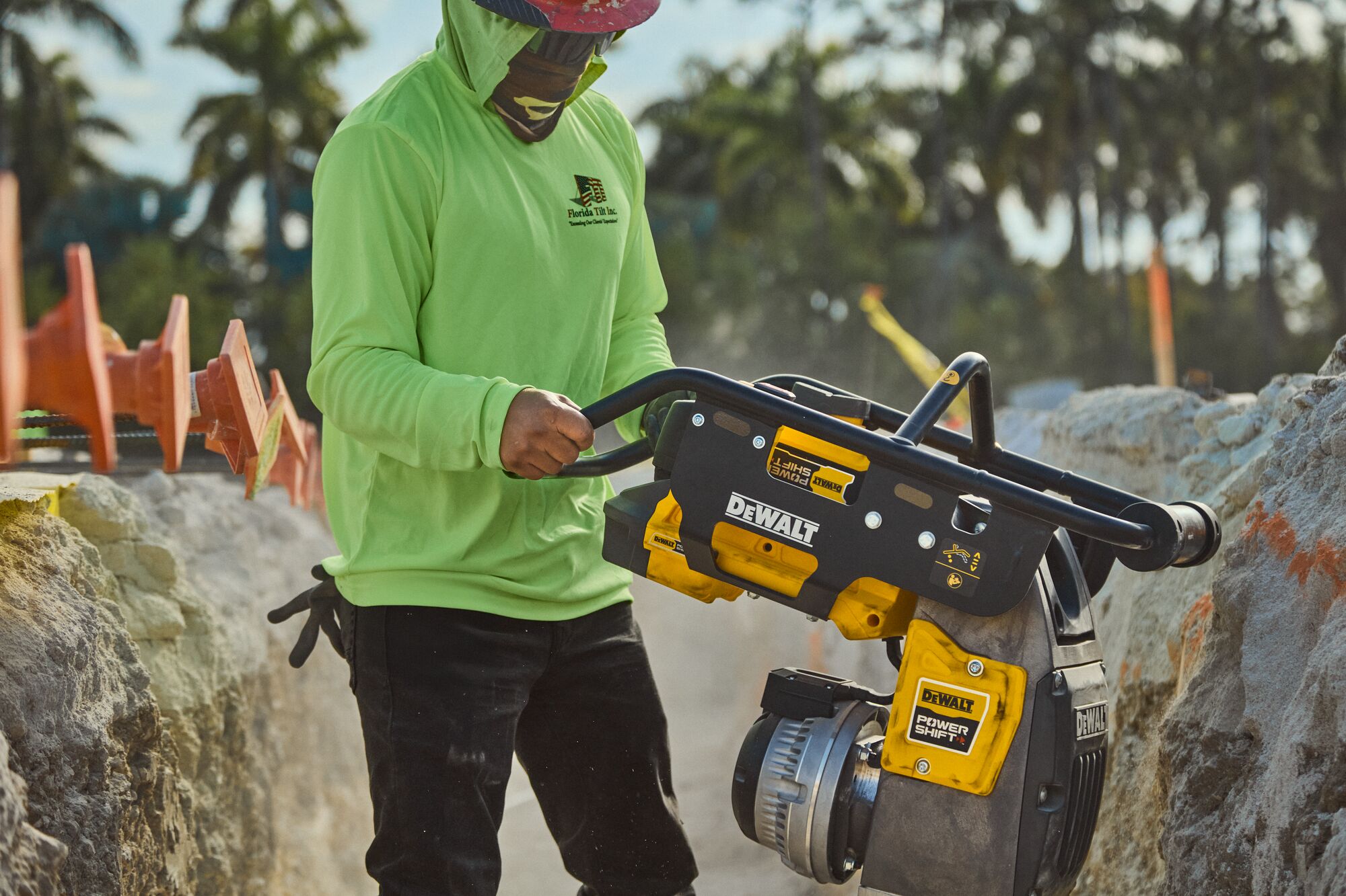 DEWALT POWERSHIFT™ rammer compacting sand in trench