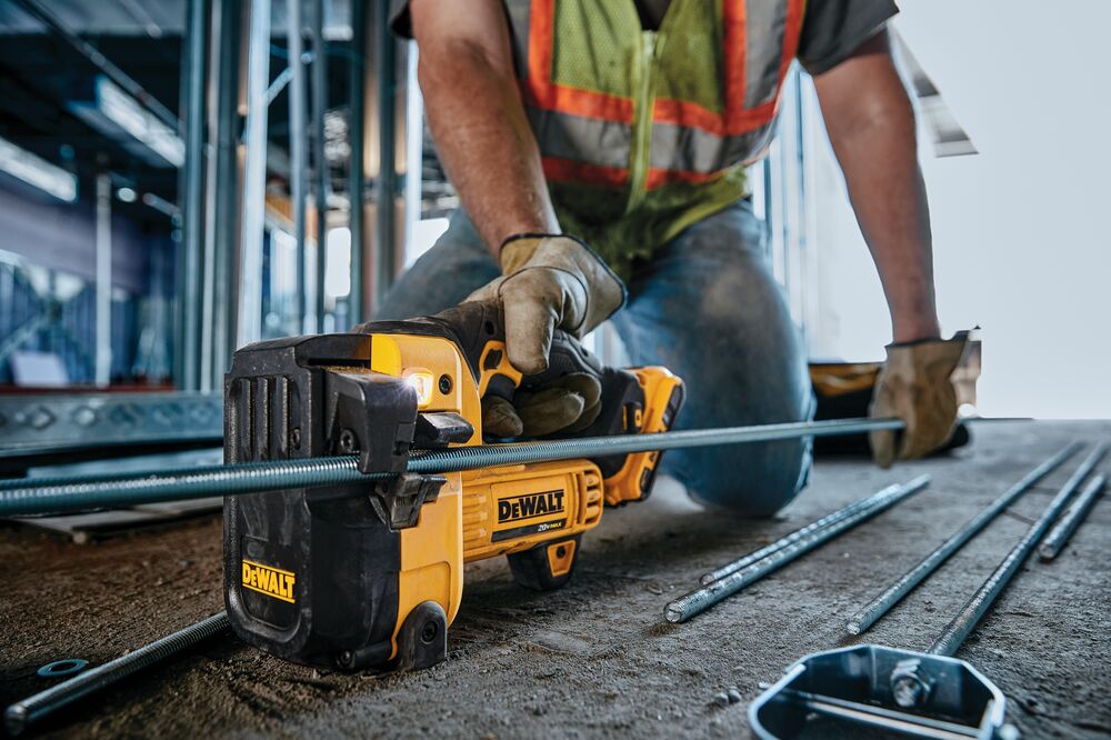 Threaded Rod Cutter being used by worker to cut threaded steel rod at construction site