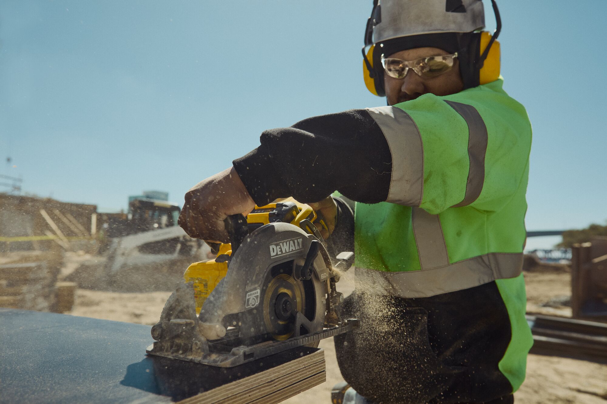 DEWALT 60V MAX* worm drive style saw ripping through wood sheets