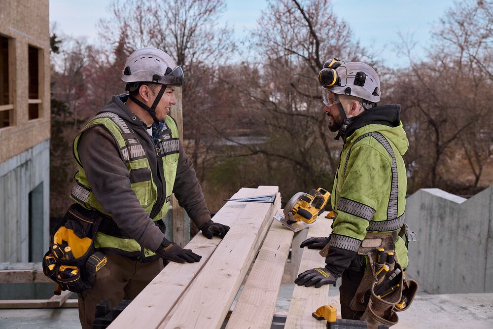 Two carpenters talk on the jobsite