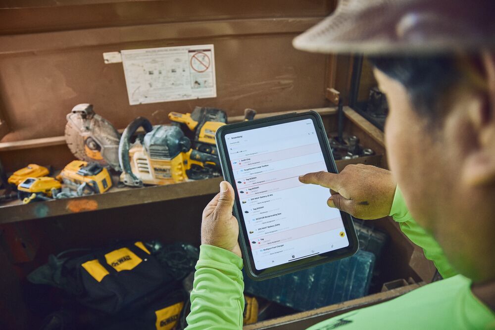 Concrete worker checking tool crib inventory with Site Manager