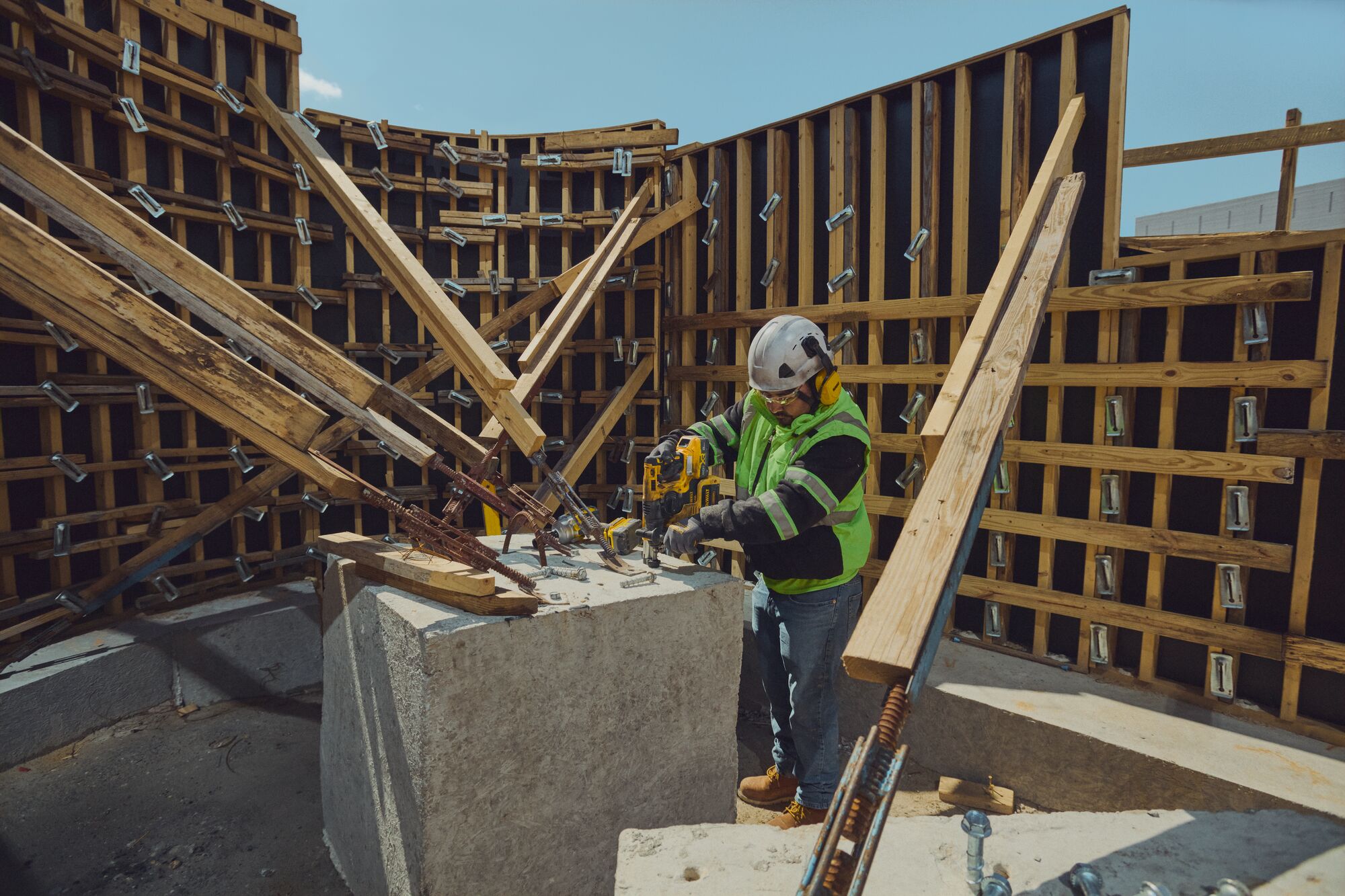 Concrete worker drilling hole for forms