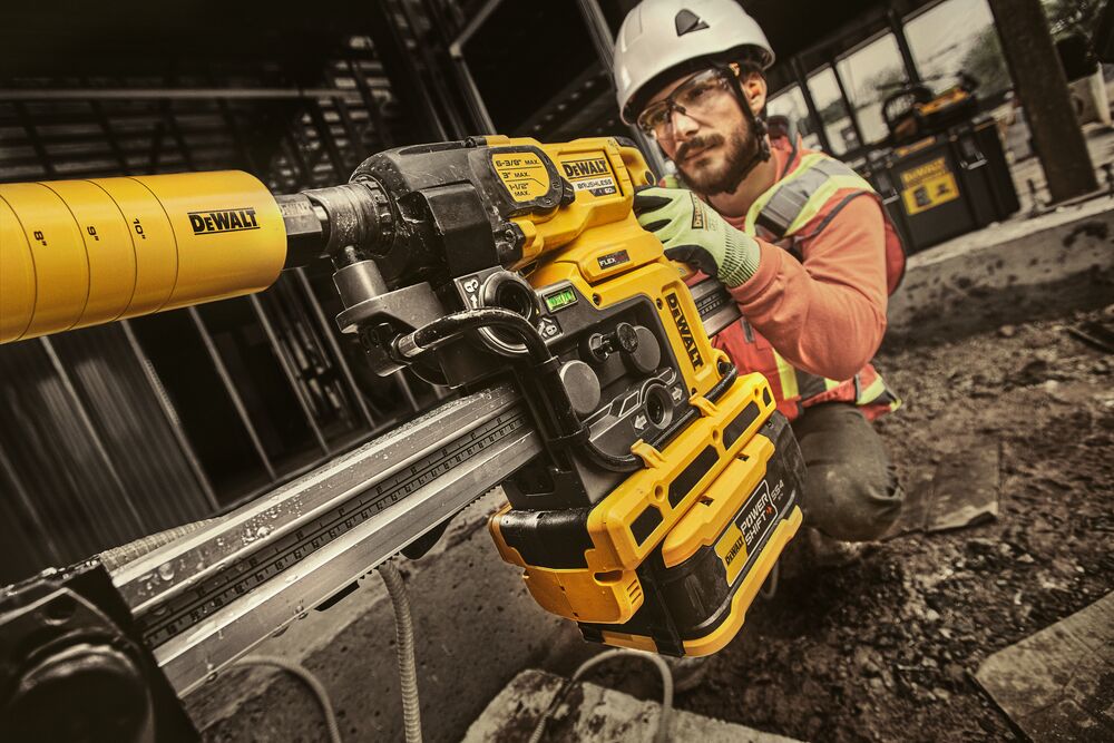 Man drilling hole in wall with core drill