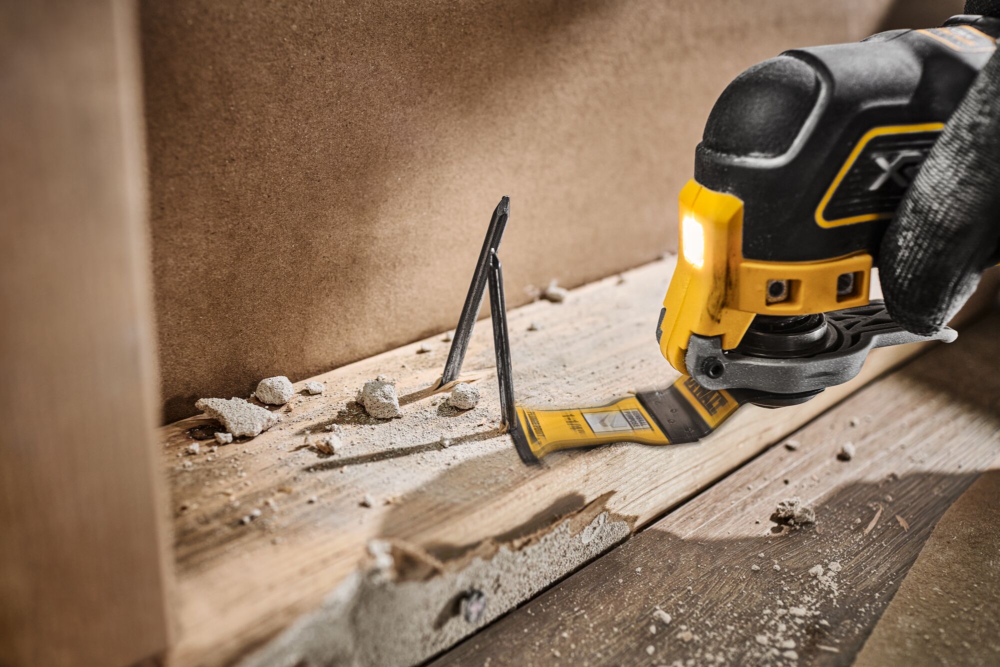 DEWALT Oscillating blade cutting nail out of wood