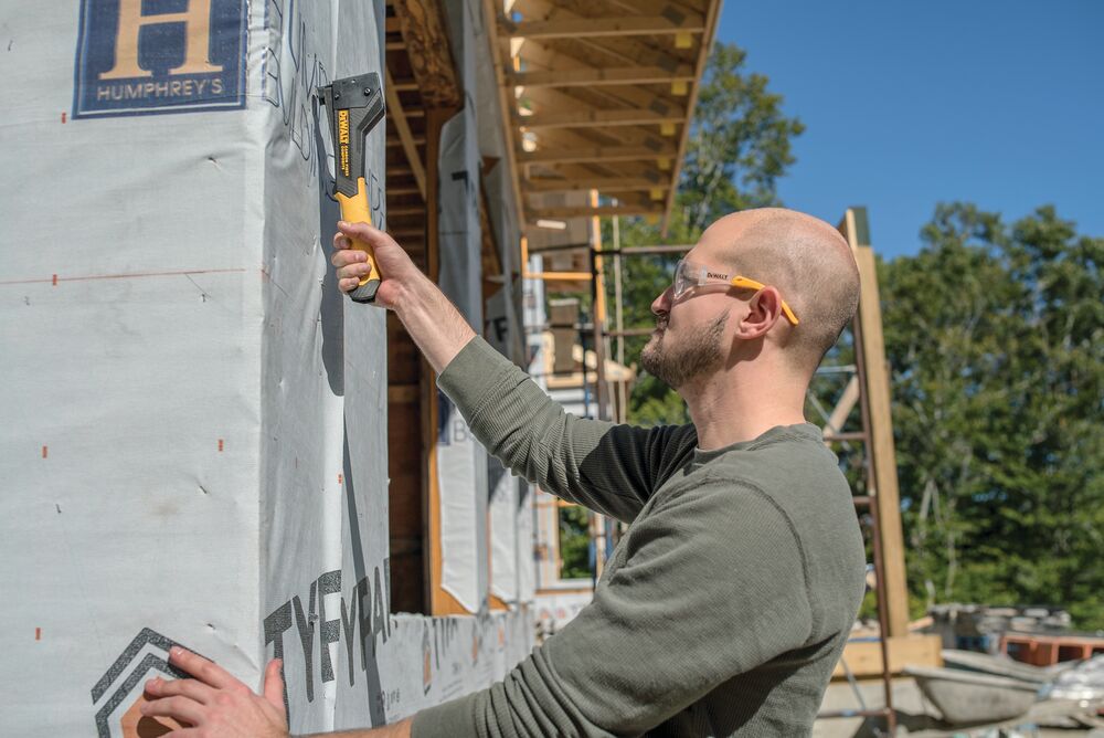 Carbon Fiber Composite Hammer Tacker being used on a construction site by a person.