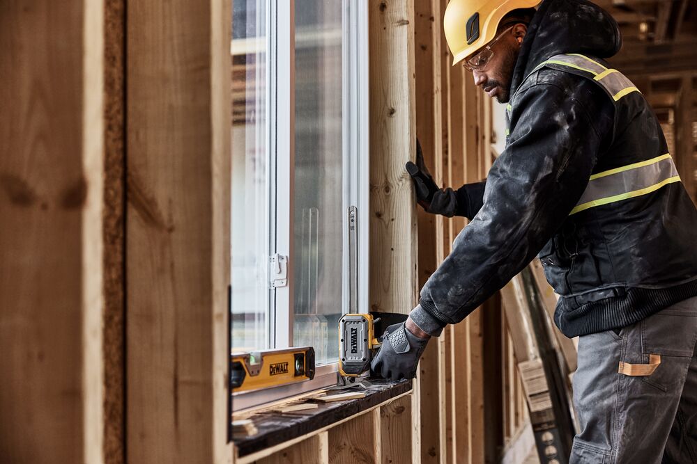 Worker lifting a window with DEWALT(R) TOUGHSERIES(TM) CONSTRUCTION JACK 