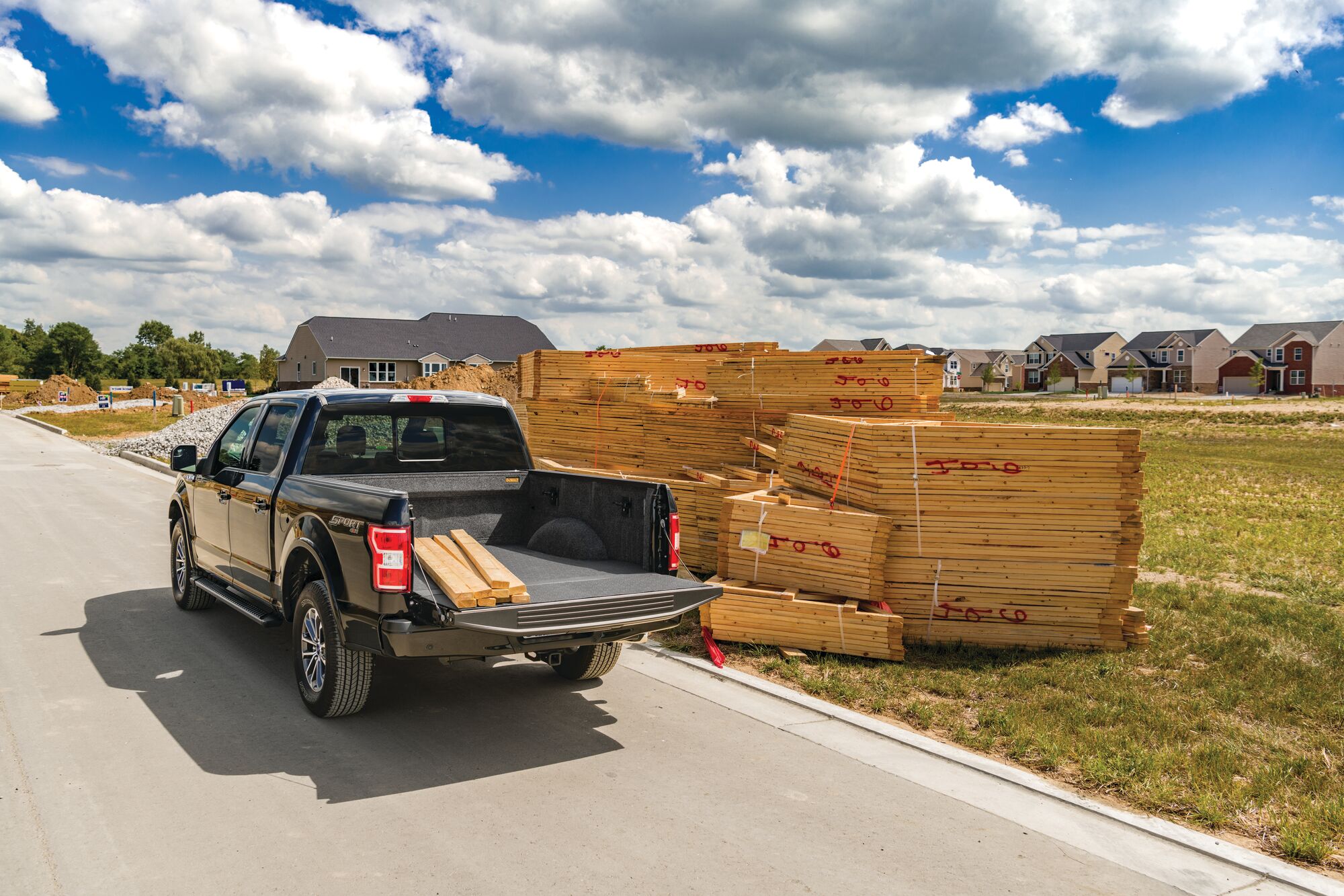 Impact Liners in truck on a road carrying wooden planks.