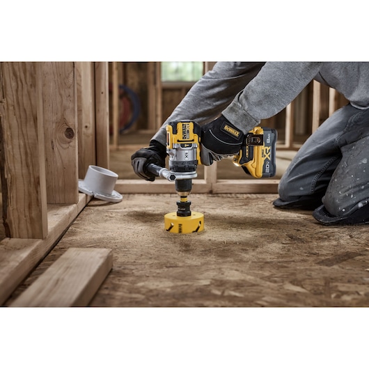 20V MAX* XR® Brushless Cordless 1/2 in. Hammer Drill drilling 4" hole for plumbing using a DEWALT hole saw