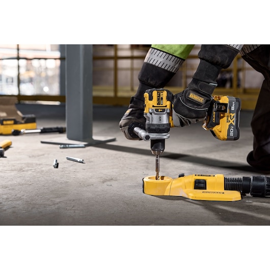 20V MAX* XR® Brushless Cordless 1/2 in. Hammer Drill drilling into concrete with dust extractor 