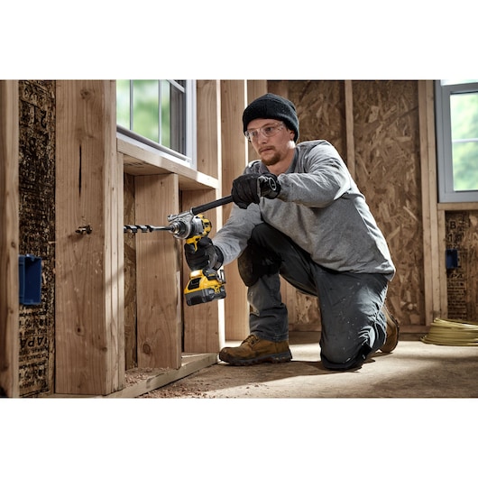 20V MAX* XR® Brushless Cordless 1/2 in. Hammer Drill drilling 7/8" hole for electrical using a DEWALT bit