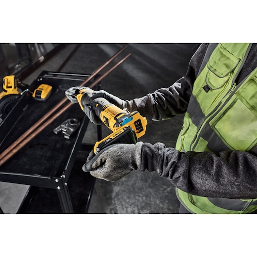 Tradesman is putting a 2AH battery on the DEWALT Compact Press Tool; you can also see the tool connect chip installed.