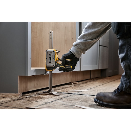 Worker lifting a cabinet with DEWALT(R) TOUGHSERIES(TM) CONSTRUCTION JACK 