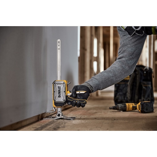 Worker lifting drywall with DEWALT(R) TOUGHSERIES(TM) CONSTRUCTION JACK 