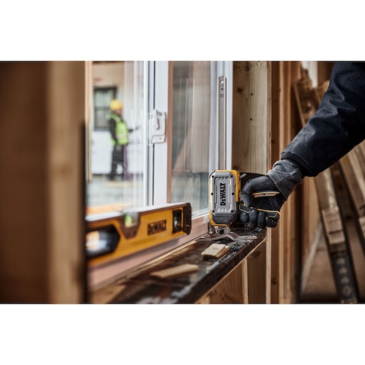 Worker lifting a window with DEWALT(R) TOUGHSERIES(TM) CONSTRUCTION JACK 