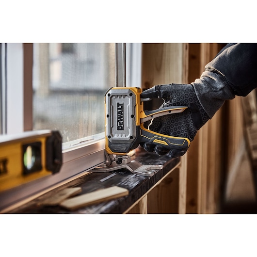 Worker leveling a window with DEWALT(R) TOUGHSERIES(TM) CONSTRUCTION JACK 