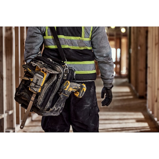 DEWALT(R) TOUGHSERIES(TM) CONSTRUCTION JACK sitting next to tool bag