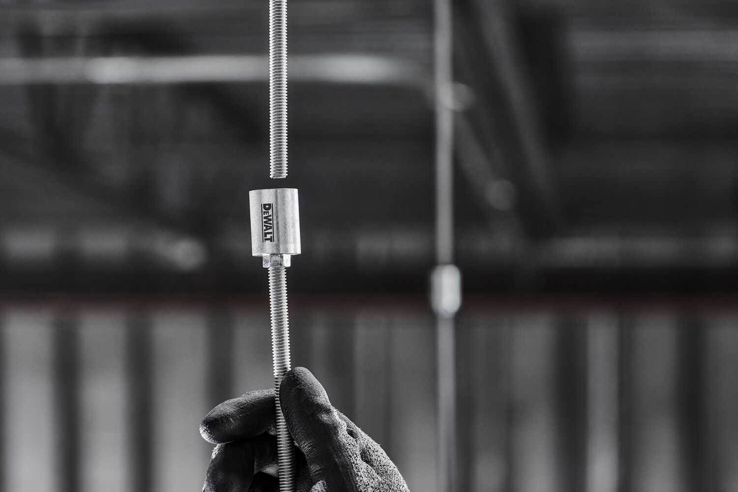 DEWALT PFM3613038 Coupler is attached to a hanging threaded rod in a mechanical room.